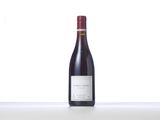 the bottle of red wine is sitting on the table