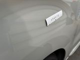 a white car with a sticker on the side of it