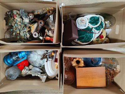 boxes filled with assorted items sitting on top of a wooden floor