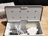 a white box that has a charger and a charger in it