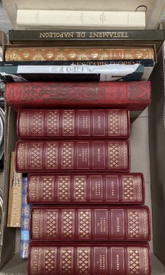 many books stacked on top of each other in a box