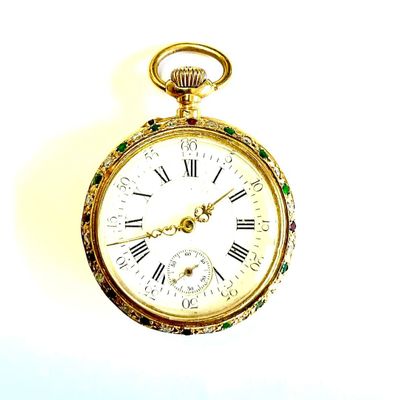a gold pocket watch with roman numerals on it
