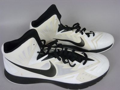 pair of white and black nike basketball shoes with black laces