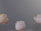 three vases that are sitting on a glass table