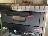 a black oven sitting on top of a counter in a kitchen