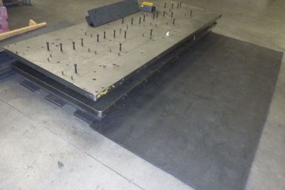 a picture of a table with nails on it in a warehouse