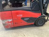 a red forklift truck parked in a warehouse