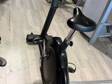 two stationary exercise bikes in a gym with mirrors