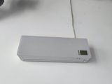 a white electronic device sitting on a table next to a bike