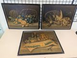 two framed paintings of fruit and vegetables on a table