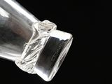 a clear glass bottle with a rope around it