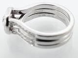 a close up photo of a diamond ring on a white surface