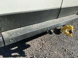 a close up of a car ' s bumper on the side of the road