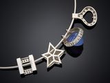 a close up of a necklace on a black surface