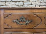 a wooden dresser with a metal handle on it