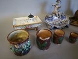 many vases and cups sitting on a table
