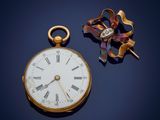 a gold pocket watch with roman numerals on it
