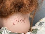 a close up of a doll ' s neck with a tattoo on it