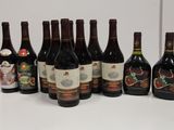several bottles of wine are lined up on a white surface