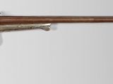 a close up of a rifle on a white background with a gray background