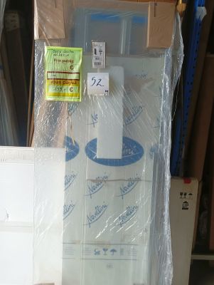 a toilet in the middle of a pile of boxes