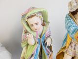 two figurines that are sitting on a table