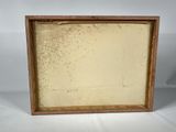 an old picture frame with a white background and a brown border