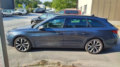 a grey car that is parked on the side of the road