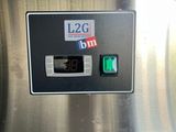 a close up of a machine with a green button