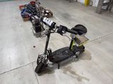 a scooter that is sitting on the floor next to other scooters