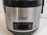a silver and black rice cooker sitting on a counter