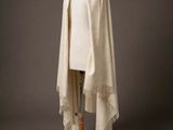 a white shawl with fringes on a mannequin mannequin