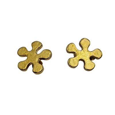 two pieces of gold colored metal on a white surface