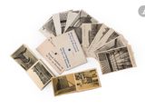 a pile of old photos and old postcards on a white surface