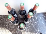 several bottles of wine sitting on top of a counter next to each other