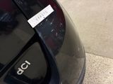 a close up of a car door handle with a sticker on it