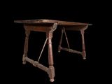 an old wooden table with two legs on a black background