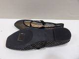 pair of women ' s shoes with black and white polka dots on them