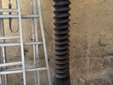 a picture of a metal pole with a piece of wood sticking out of it