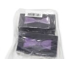 two bags of purple bow ties sitting on top of a white surface