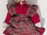 a small doll that is sitting on a white surface