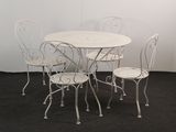 a white table and four chairs in a room