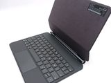 a black laptop with a black keyboard on a white surface