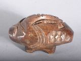 a small figurine of a fish on a table