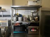 a kitchen with a stove, microwave, and other appliances in it