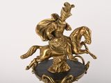 a statue of a man riding a horse on a pedestal