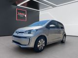 une Volkswagen e-up argentée garée dans un showroom