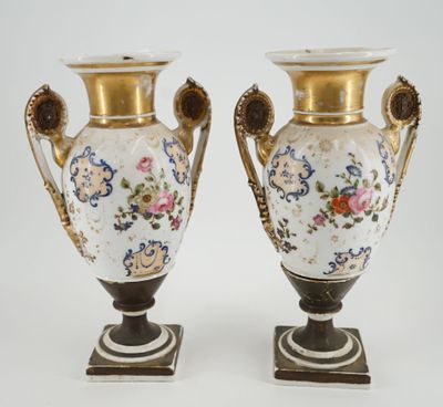 pair of antique vases with floral designs on them on a white background