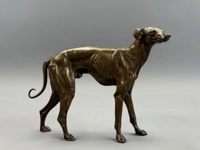 bronze statue of a greyhound dog on a gray background