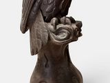 sculpture of an owl sitting on a tree stump on a white background